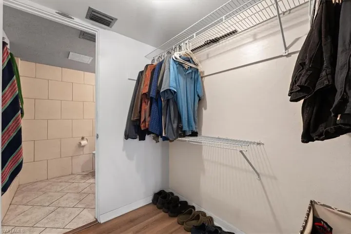Walk in closet featuring wood finished floors