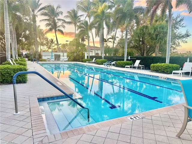 Lap pool with integrated spa and surrounding paver deck