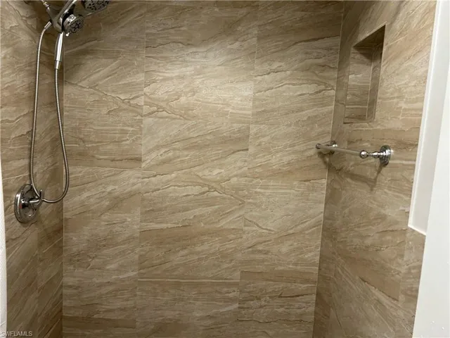 Room details with tiled shower