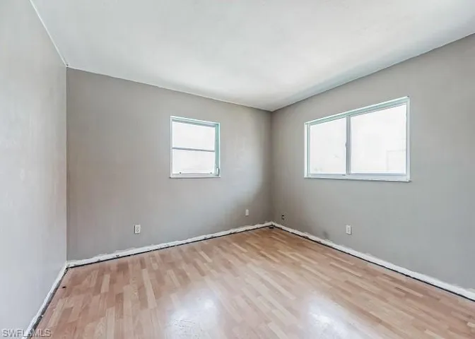 Unfurnished room featuring a healthy amount of sunlight and light wood-type flooring
