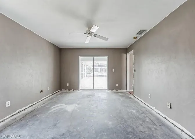 Empty room with ceiling fan and concrete flooring