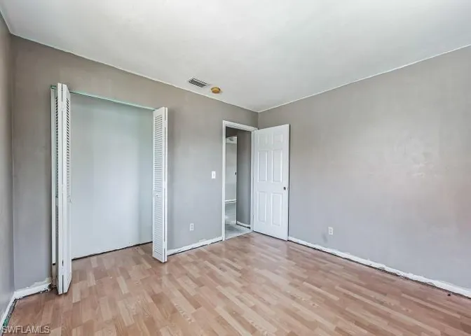 Unfurnished bedroom with a closet and light wood-type flooring