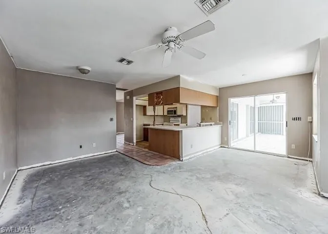 Unfurnished living room featuring ceiling fan