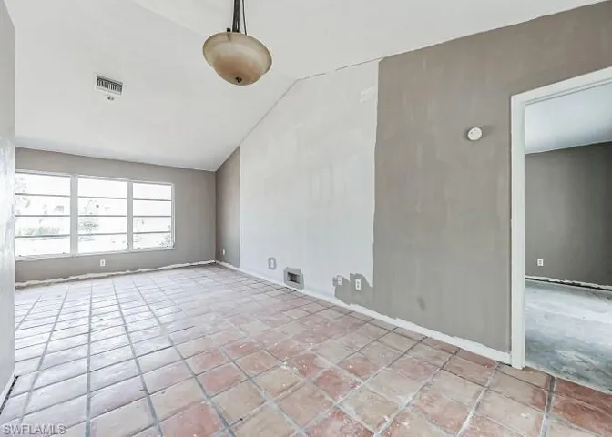 Unfurnished room with light tile floors