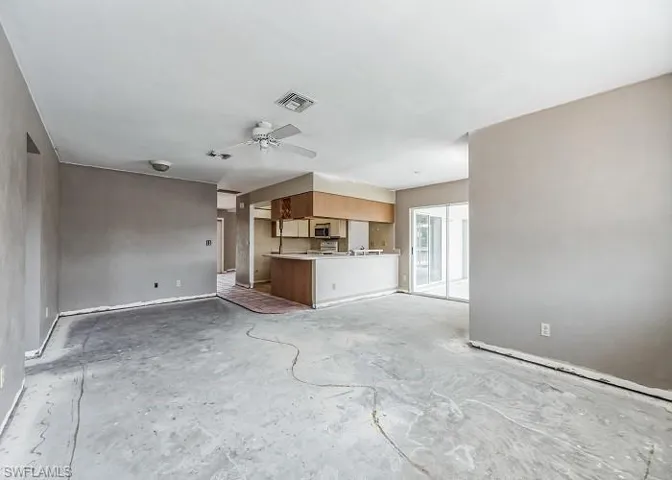 Unfurnished living room featuring ceiling fan