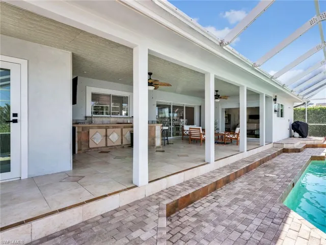 View of patio / terrace with an outdoor pool, area for grilling, and a ceiling fan