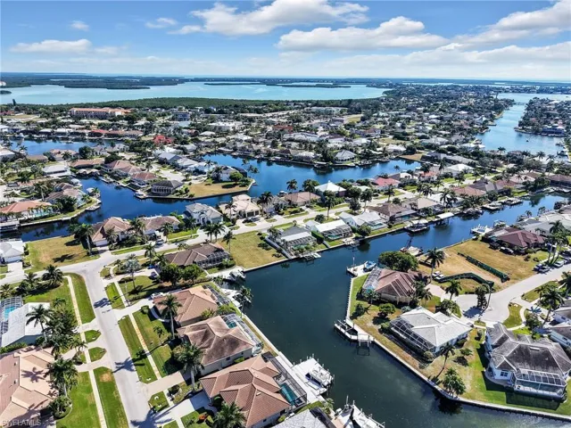 Aerial view of residential area featuring a large body of water