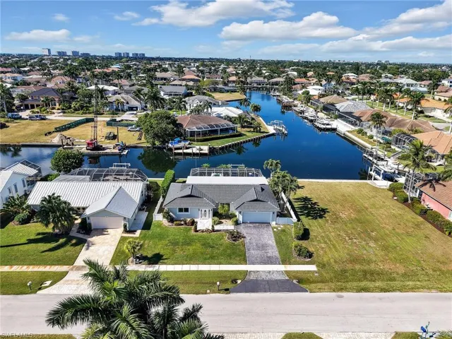 Aerial view of residential area featuring a nearby body of water