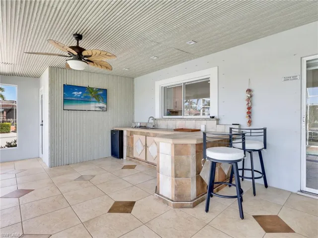 View of patio with a ceiling fan and area for grilling
