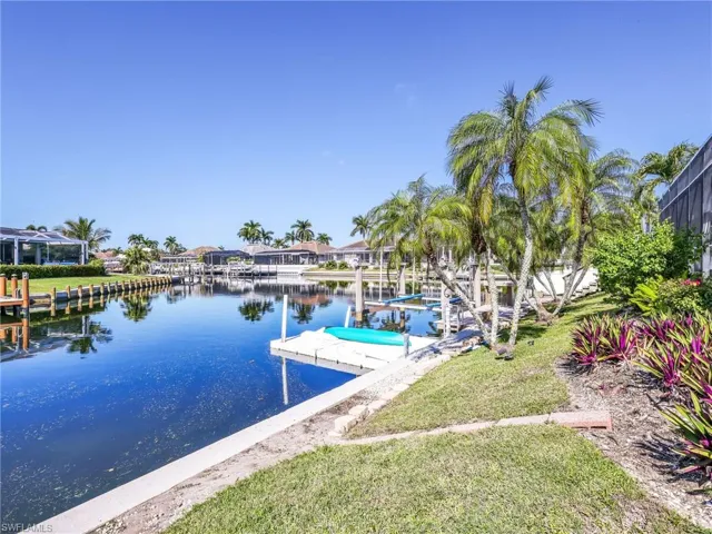 Dock area featuring a water view and a yard