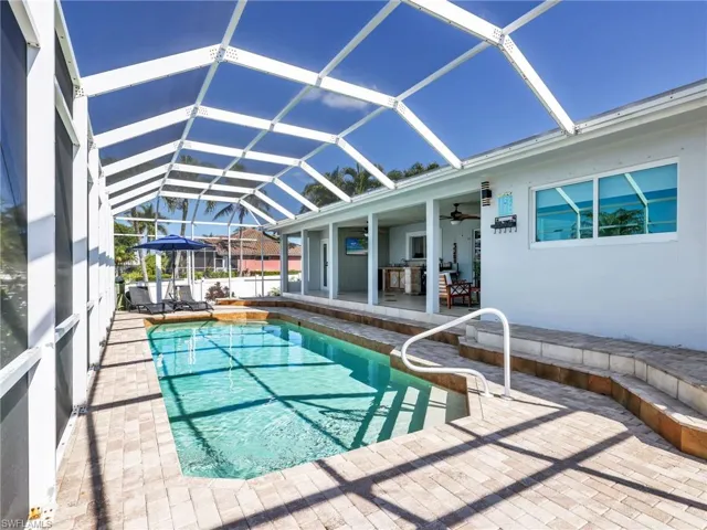 Swimming pool with a patio, glass enclosure, a sunroom, and ceiling fan