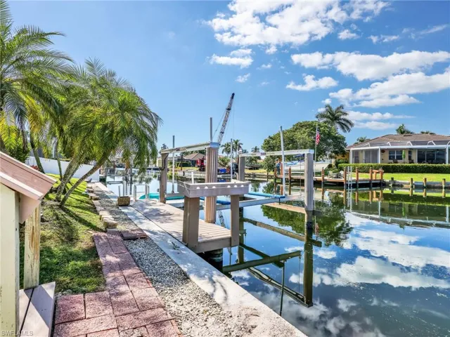 Dock with boat lift and a water view