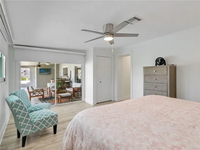 Bedroom with light wood finished floors and a ceiling fan