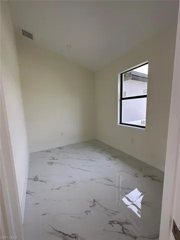 Empty room with light marble finish floors and baseboards