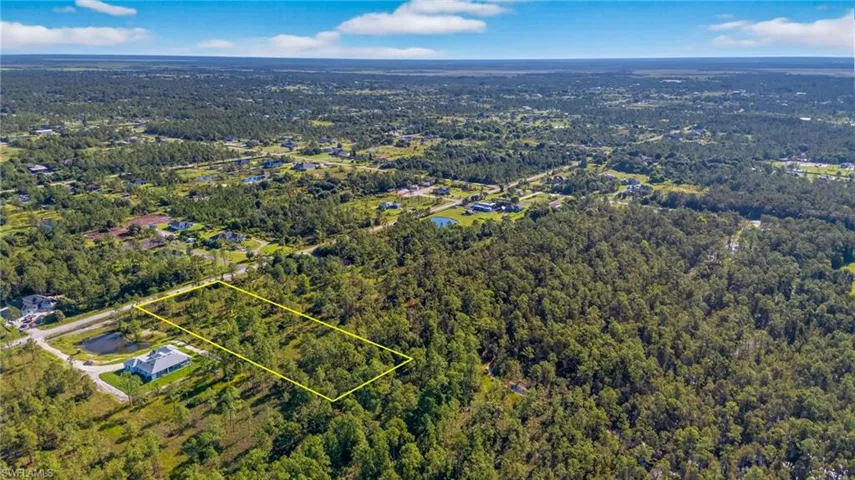 Aerial overview of property's location with property boundaries highlighted and a forest