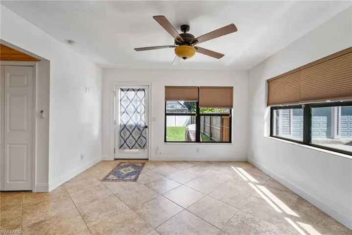 Tiled foyer entrance with ceiling fan