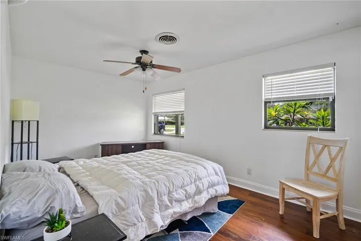 Bedroom featuring ceiling fan and dark hardwood / wood-style flooring