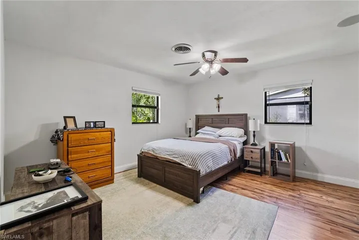 Bedroom with ceiling fan and hardwood / wood-style floors