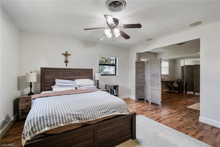 Bedroom with a closet, ceiling fan, and hardwood / wood-style flooring