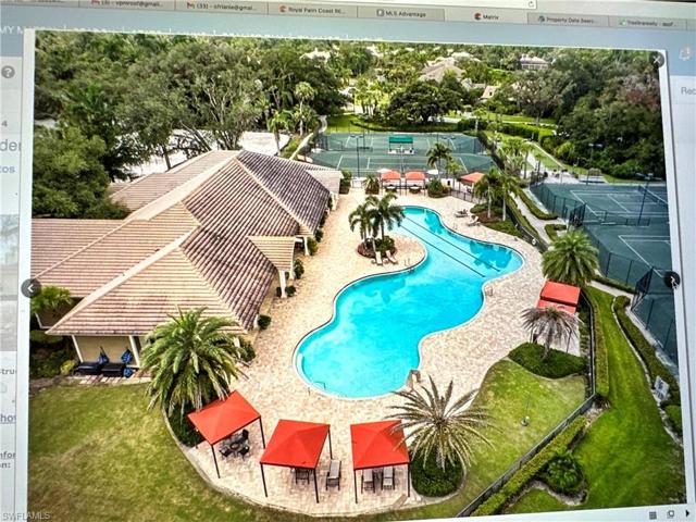 Overview of Verandah Community Pool and tennis courts. The Fitness Center is the building picture too.