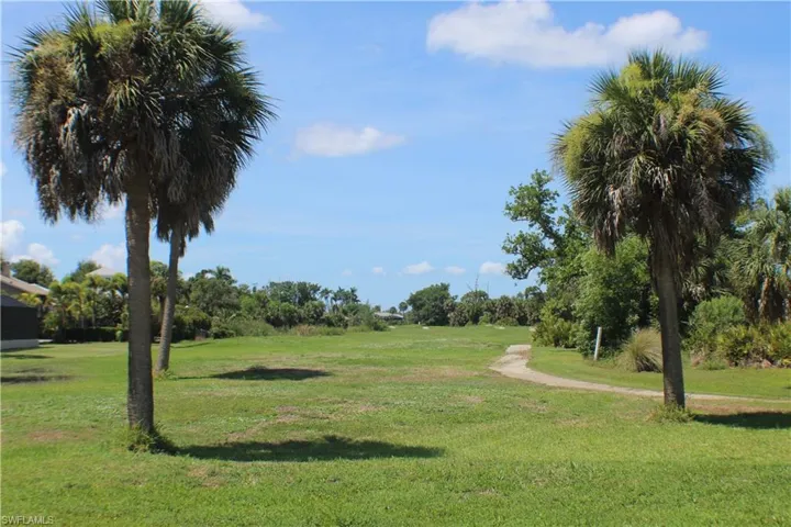 View of property's community with a yard