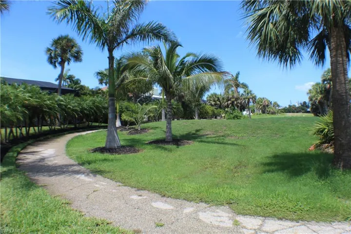 View of home's community with a yard
