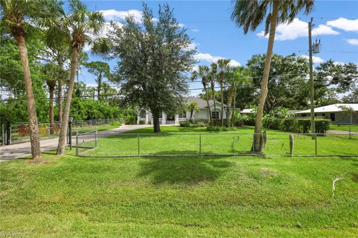The front yard is also vast, with lush green grass