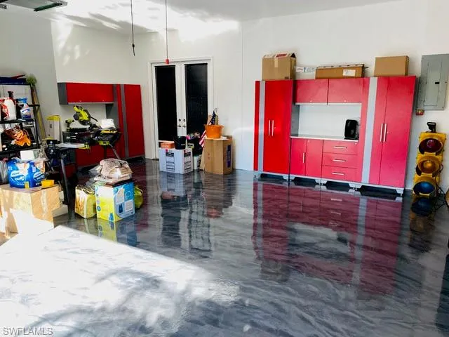 A clean & sleek 3 car garage with easy to maintain coated floors