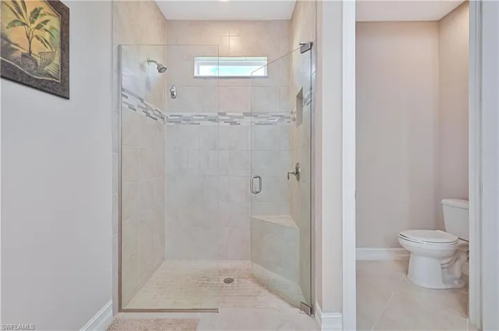 Full bathroom with a stall shower and tile patterned flooring