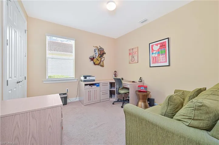 Home office featuring light carpet and baseboards