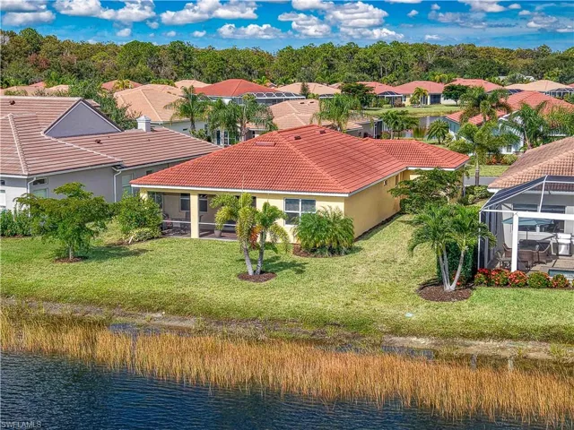 Aerial view of residential area featuring a large body of water