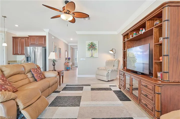 Living area with ceiling fan, crown molding, and recessed lighting