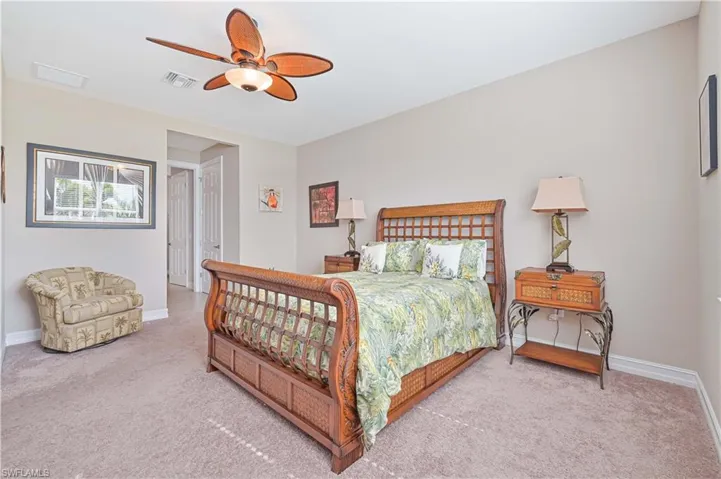 Bedroom with light carpet and a ceiling fan