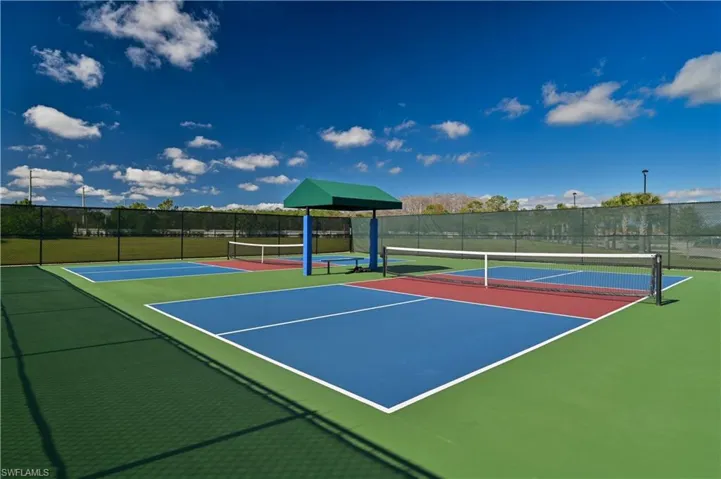 View of tennis court with community basketball court