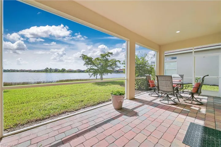 View of patio with a water view and outdoor dining area