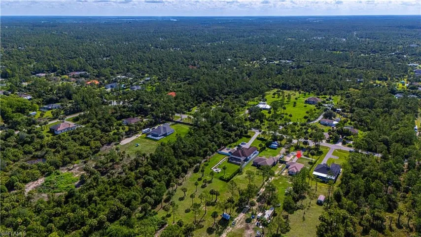 Aerial view of property's location with a forest