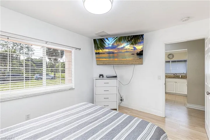 Bedroom with light wood-style flooring and a sink