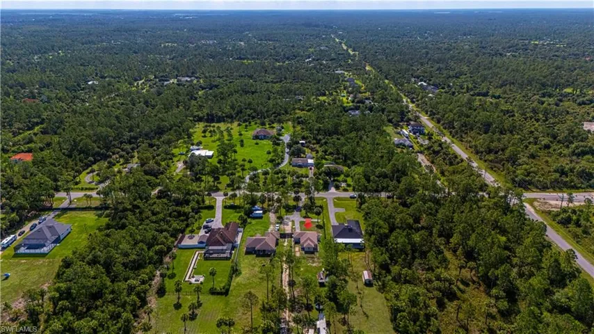 View of property location featuring a forest