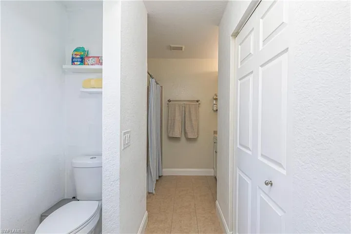 Full bath with tile patterned flooring and toilet