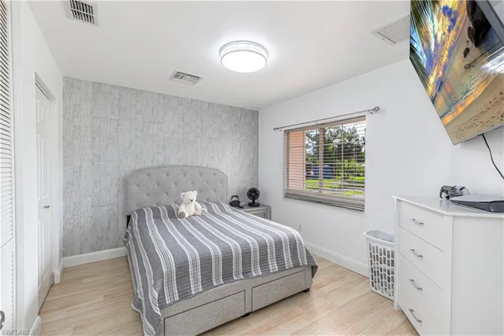 Bedroom featuring baseboards and light wood-type flooring