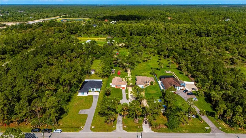 Aerial overview of property's location with a heavily wooded area