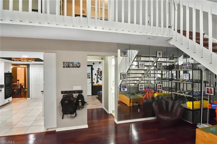 Stairway featuring wood finished floors