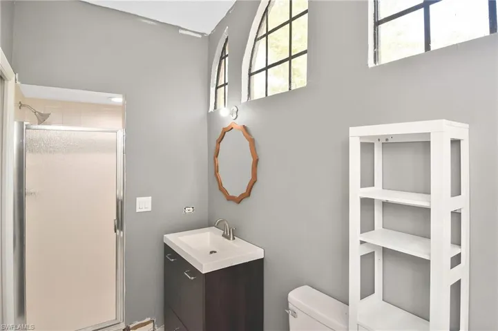 Bathroom featuring vanity and a shower stall