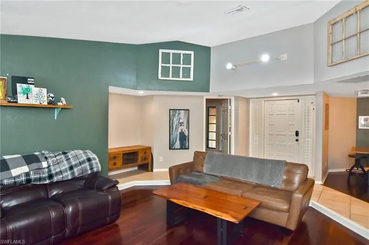 Living room with lofted ceiling and wood finished floors