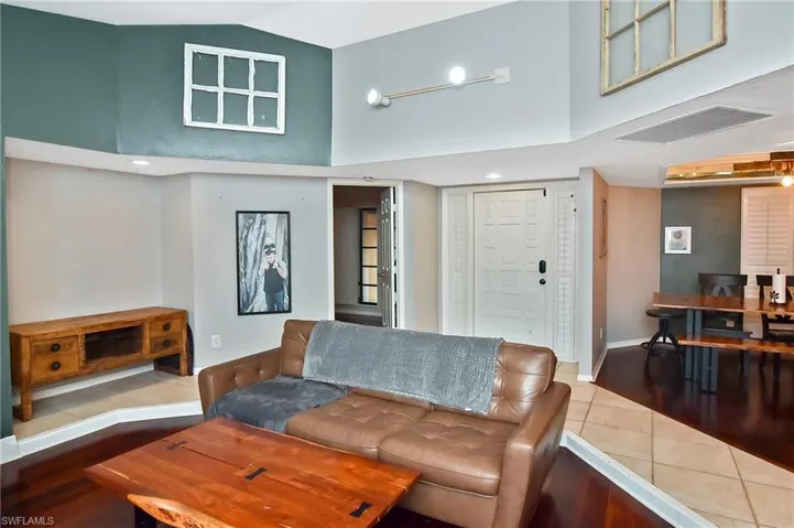 Living room with wood finished floors and vaulted ceiling
