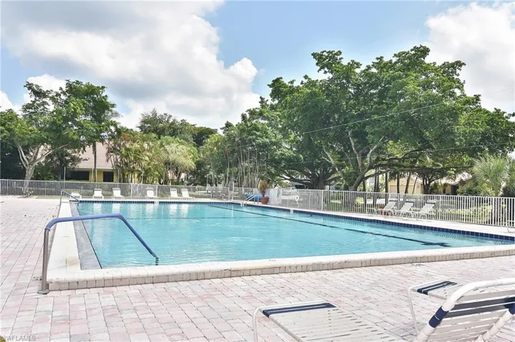 Community pool with a patio