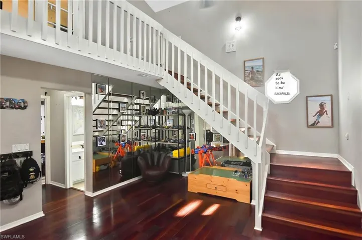 Stairs featuring wood finished floors and baseboards