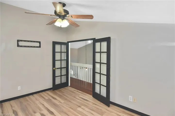 Spare room with light wood-style flooring, ceiling fan, and french doors