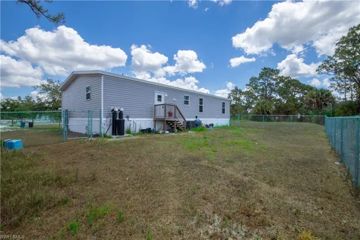 Rear view of house with a lawn