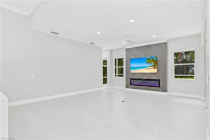Living room with feature wall with Tv and fireplace
